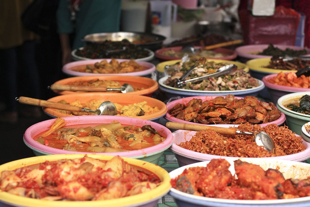 A colorful spread of Indonesian food from a brightly lit restaurant